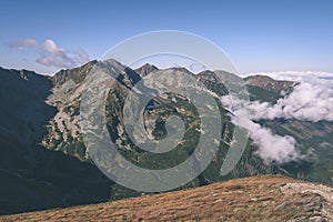 Mountain tops in autumn covered in mist or clouds- vintage effe