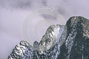 Mountain tops in autumn covered in mist or clouds- vintage effe