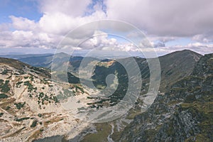 Mountain tops in autumn covered in mist or clouds- vintage effe