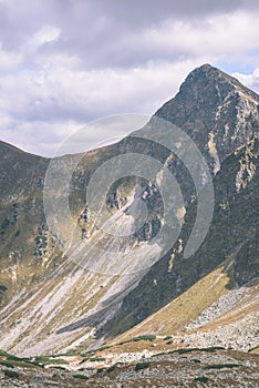 Mountain tops in autumn covered in mist or clouds- vintage effe