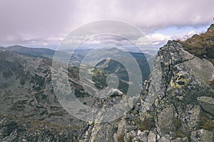 Mountain tops in autumn covered in mist or clouds- vintage effe