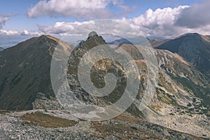 Mountain tops in autumn covered in mist or clouds- vintage effe