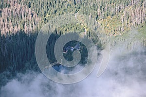 Mountain tops in autumn covered in mist or clouds - vintage ret