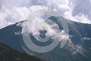 Mountain tops in autumn covered in mist or clouds - vintage ret