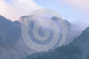 Mountain tops in autumn covered in mist or clouds - vintage ret