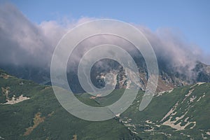 Mountain tops in autumn covered in mist or clouds - vintage ret