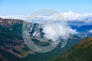 Mountain tops in autumn covered in mist or clouds