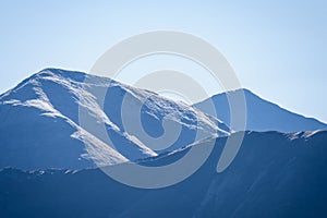 Mountain tops in autumn covered in mist or clouds