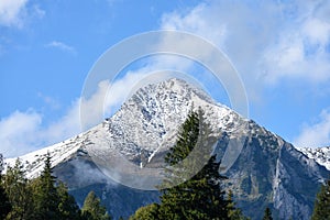 Mountain tops in autumn covered in mist or clouds