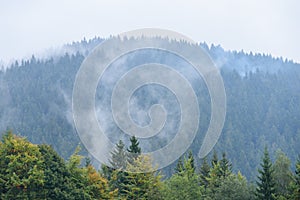 Mountain tops in autumn covered in mist or clouds