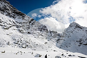 Mountain tops in winter covered in snow with bright sun and blue