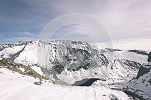 Mountain tops in winter covered in snow - vintage film look