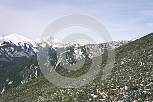 Mountain tops in winter covered in snow - vintage film look