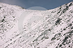 Mountain tops in winter covered in snow - vintage film look