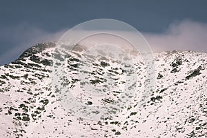 Mountain tops in winter covered in snow - vintage film look