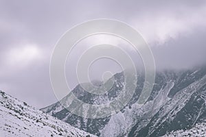 Mountain tops in winter covered in snow - vintage retro look