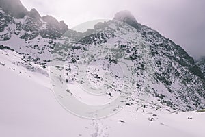 Mountain tops in winter covered in snow - vintage retro look