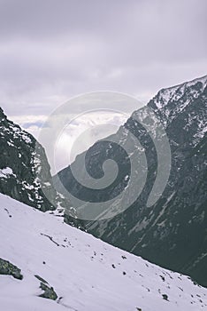 Mountain tops in winter covered in snow - vintage retro look