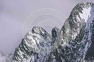 Mountain tops in winter covered in snow - vintage retro look