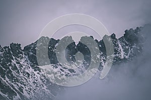 Mountain tops in winter covered in snow - vintage retro look