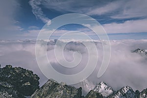 Mountain tops in winter covered in snow - vintage retro look