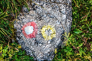 Mountain trail marker on a stone or a rock.