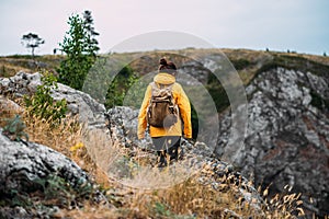 Mountain traveler, rear view. Mountain sports. Mountain tourism. Walking tour. The journey to the mountains. Traveling woman