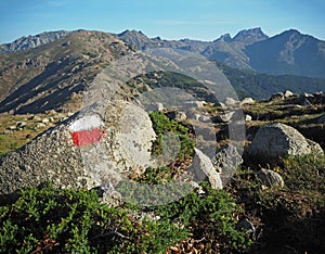 Mountain trek - granite boulder marked with red and white