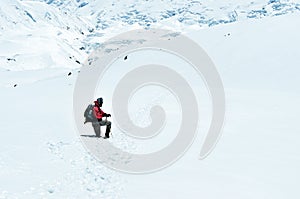 Mountain trekker struggling through the snowed landscape, Himalayas