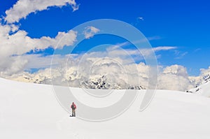 Mountain trekker walking in high winter Himalayas mountains