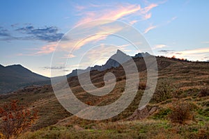 Mountain valley with cloudy sky sunset