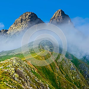 mountain valley in dense mist and clouds