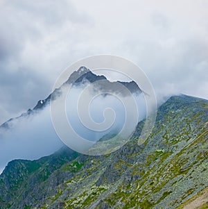 mountain valley in dense mist and clouds