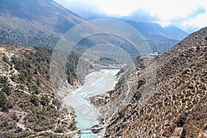 Mountain valley with flowing river in Himalayas photo