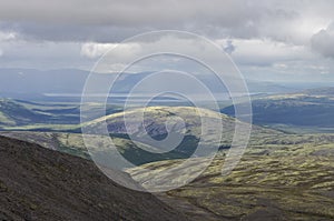 Mountain valley with mosses and rocks covered with lichens. Cloudy sky before storm. Khibiny mountains above the Arctic