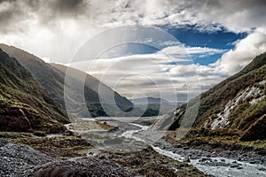 Mountain valley with the river. New Zealand. One can see rain on the left hand side of the breathtaking image. New Zealand south