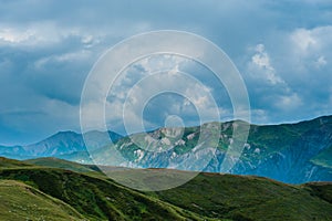 Mountain valley with snow peaks and clouds in Tetnuldi