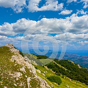 mountain valley under a blue cloudy sky