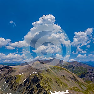 mountain valley under a blue cloudy sky