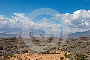 Mountain and valley view along Wadi Sahtan road in Al Hajir mountains between Nizwa and Mascat in Oman photo