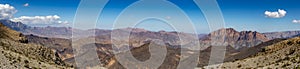 Mountain and valley view along Wadi Sahtan road in Al Hajir mountains between Nizwa and Mascat in Oman photo