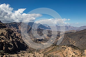 Mountain and valley view along Wadi Sahtan road in Al Hajir mountains between Nizwa and Mascat in Oman photo