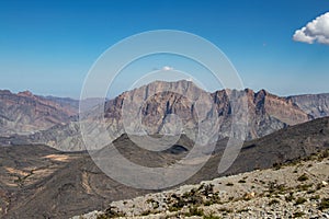 Mountain and valley view along Wadi Sahtan road in Al Hajir mountains between Nizwa and Mascat in Oman photo