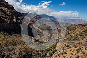 Mountain and valley view along Wadi Sahtan road in Al Hajir mountains between Nizwa and Mascat in Oman photo