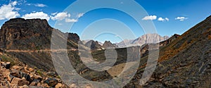 Mountain and valley view along Wadi Sahtan road and snake canyon in Al Hajir mountains between Nizwa and Mascat in Oman photo