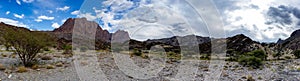 Mountain and valley view along Wadi Sahtan road and snake canyon in Al Hajir mountains between Nizwa and Mascat in Oman photo