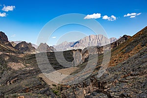 Mountain and valley view along Wadi Sahtan road and snake canyon in Al Hajir mountains between Nizwa and Mascat in Oman photo