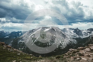 Mountain valleys and peaks of the Rocky Mountains. Gloomy snow clouds