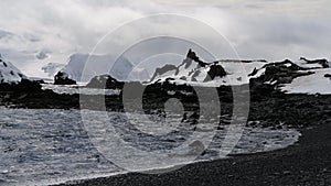 Mountain view in Antartica with reflection in water