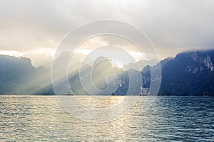 Mountain view with lake and sunray pass through the cloud